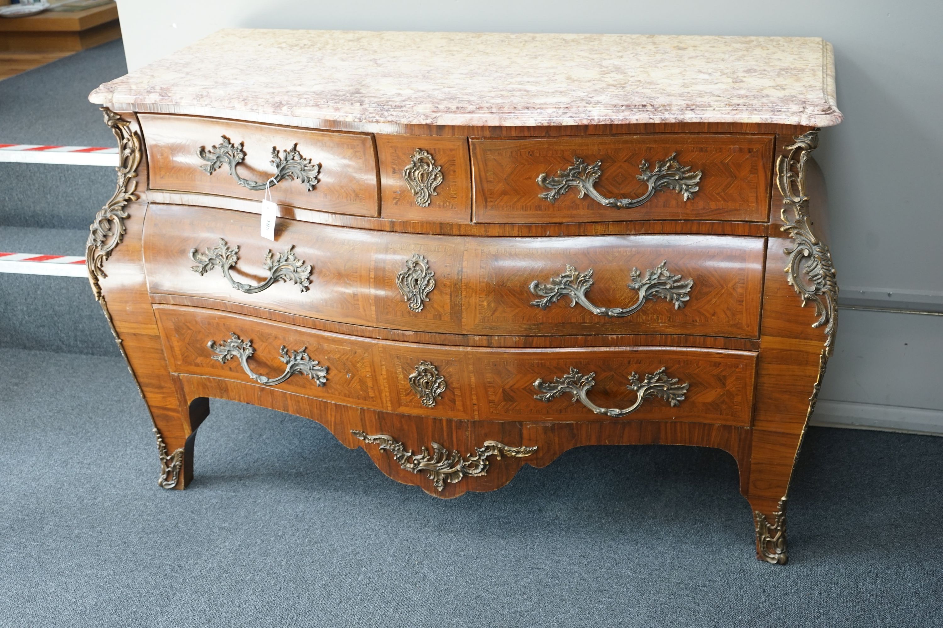 A Louis XV style marble topped serpentine bombe commode - impressed maker's stamp, M.P., width 140cm, depth 59cm, height 90cm